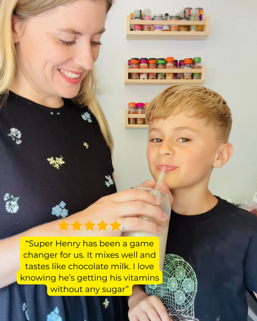 Mum watching her child enjoy Super Henry chocolate greens mixed into milk.