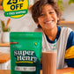 Child enjoying Super Henry chocolate greens with a glass of chocolate milk.